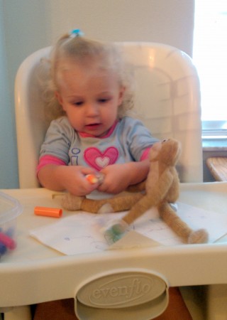 Teaching one of her monkeys how to draw. Notice she is putting a marker in each paw.