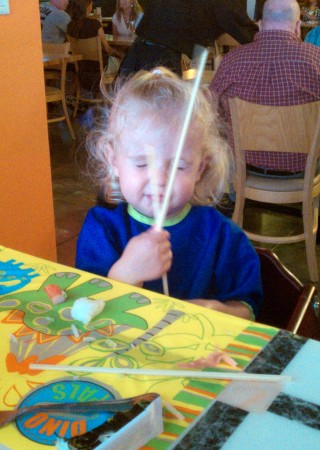 She is still working on her chopstick skills.