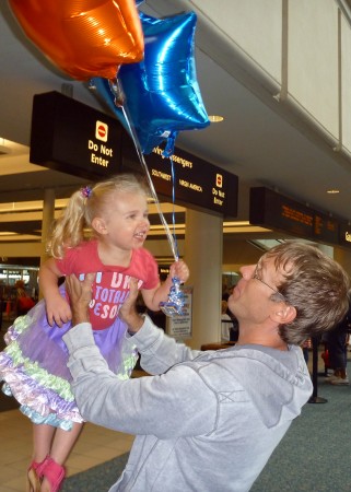 Picking Daddy up at the airport after he had been gone 2 weeks. She picked out the "My Dad is Totally Awesome" shirt to wear along with the skirt and balloons.