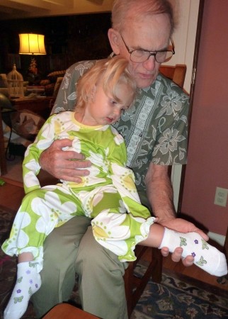 Showing off her socks to Great-grandpa Kennard.