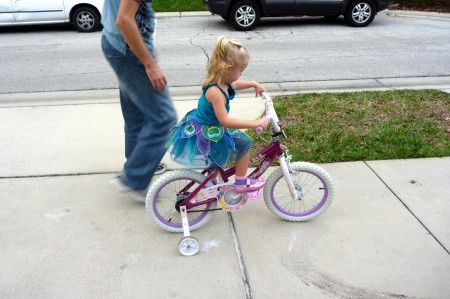 Riding her new bike.